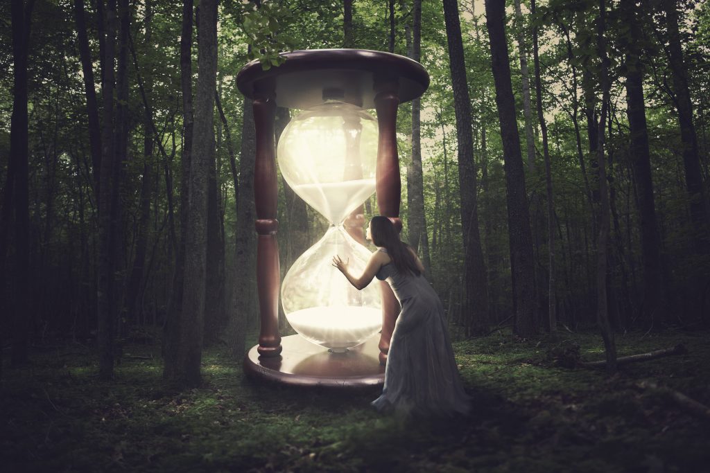 Huge Hourglasswith woman peering in